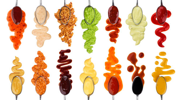 Different sauces isolated on white background Set of different sauces with spoons isolated on white background with clipping path stuffing food photos stock pictures, royalty-free photos & images