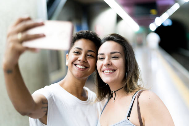 istock Lesbian Couple Taking a Selfie at Subway Station 955422348