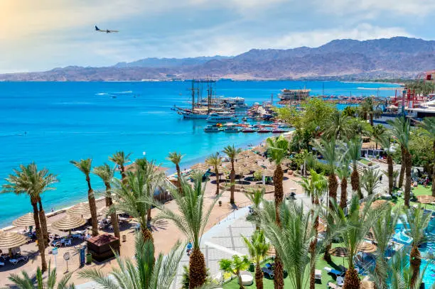 Eilat is a famous Israeli resort city with beautiful sandy beaches, hot sun and clear blue skies, surrounded by stunning mountains and desert scenery. It is very popular tropical getaway for tourists