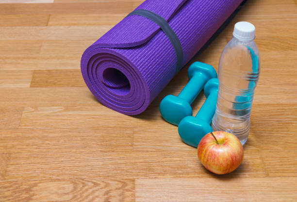 istock Yoga mat, dumbbells, apple and bottle of water 955439708