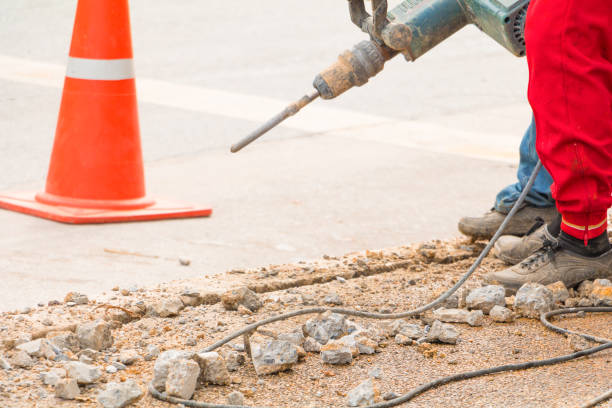 istock construction drilling repair worker on road surface with heavy duty machine drill motion 955445312