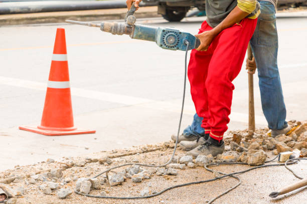 istock construction drilling repair worker on road surface with heavy duty machine drill motion 955445330