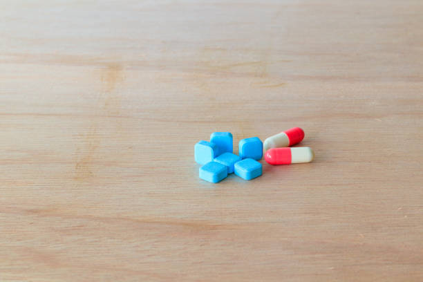 istock pills blue and capsule On wooden floor with copy space add text  ( high definition image ) 955447952