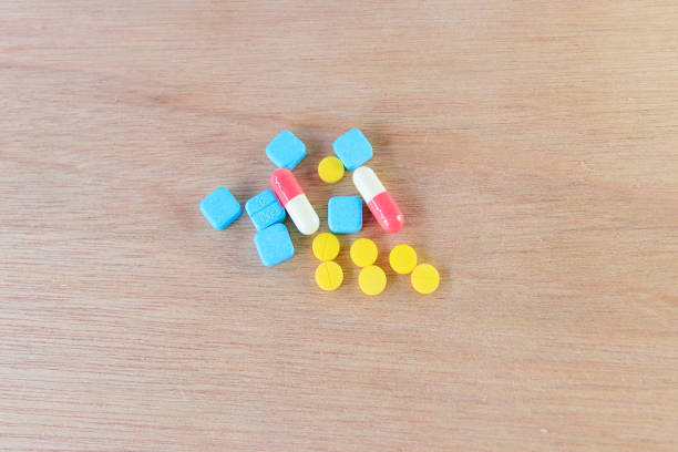 istock pills  and capsule On wooden floor with copy space add text  ( high definition image ) 955448106