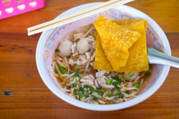 istock Noodle soup with pork balls with fried dumplings, Thai Food 955449616
