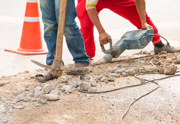 istock construction drilling repair worker on road surface with heavy duty machine drill motion 955452744
