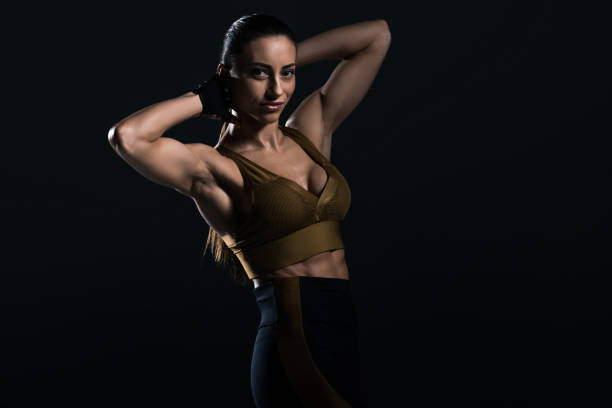 istock attractive strong bodybuilder posing and showing muscles, isolated on black 955453006