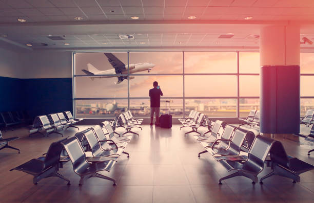 istock Passenger at the airport and landing airplane 955457450