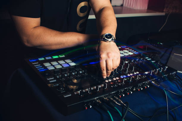 istock DJ plays hands on professional mixer at night club 955459208