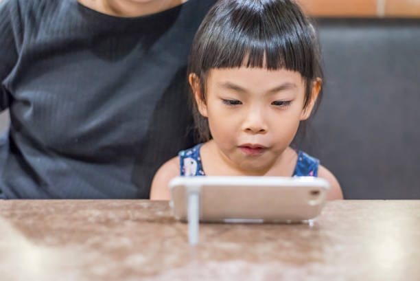 istock Child's happy moment with smart phone 955459416