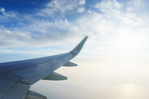 istock Traveling by plane. View from the window to the clouds and blue sky. 955461680