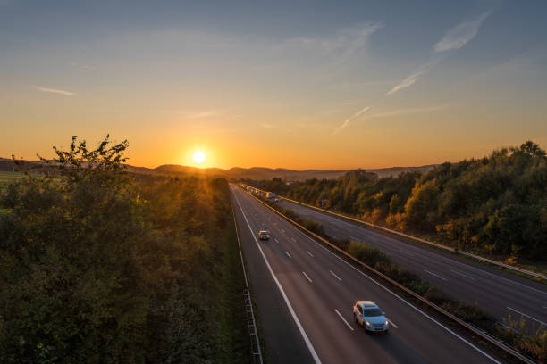 istock The road traffic on a motorway at sunset 955466616