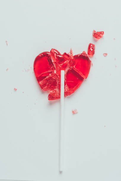 istock top view of broken heart shaped lollipop isolated on white 955467890