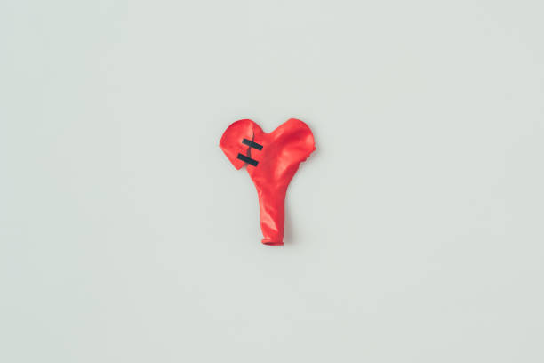 istock top view of broken heart shaped balloon with insulating tape isolated on white 955471668