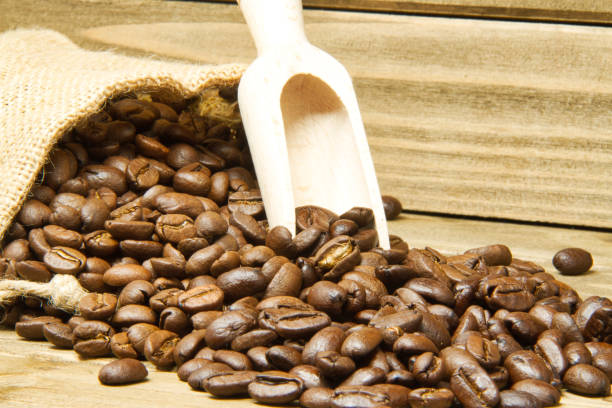 istock Spilled Coffee Beans from a Burlap Sack 955472614