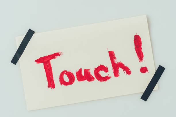 istock top view of note with word touch isolated on white 955477014