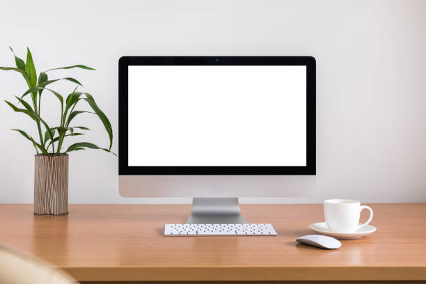 istock All in one computer, mouse, keyboard, coffee cup and plant vase  on wooden table 955488004