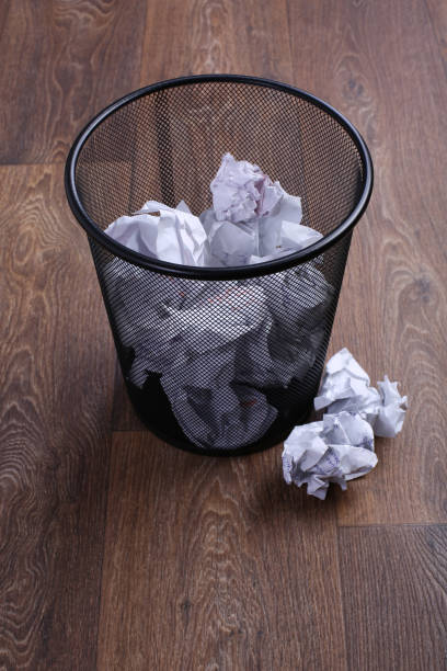 istock Wastepaper backet on the wooden floor 955491096