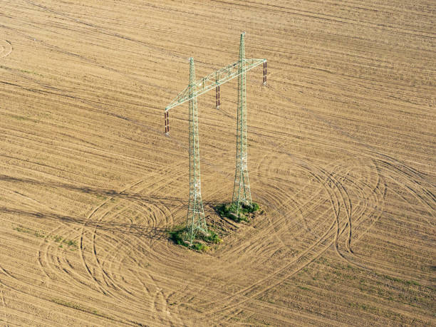 istock Mast electrical power line in field 955491642