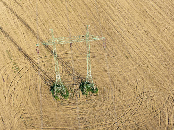 istock Mast electrical power line in field 955491748