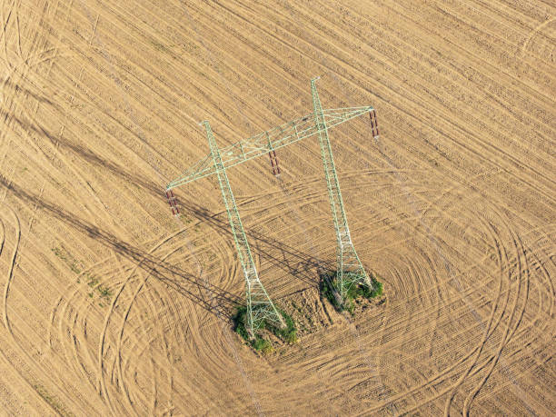 istock Mast electrical power line in field 955491762