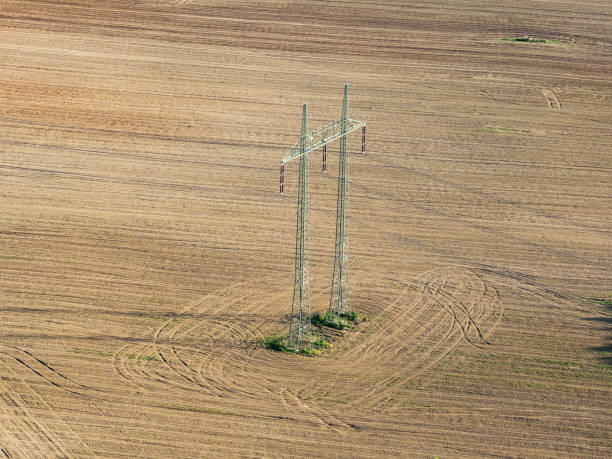 istock Mast electrical power line in field 955491830