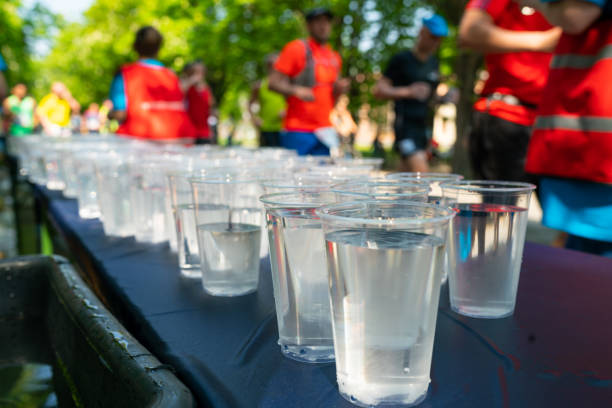 many cups of water on table of refreshment point of marathon run