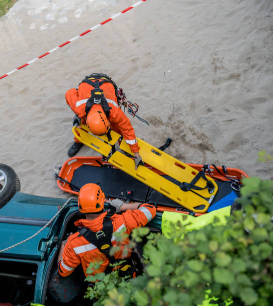Firefighters in a rescue operation of car accident; all logos removed. Slovenia, Europe. Nikon.