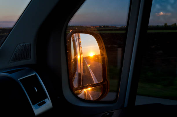 istock Side rear-view mirror in the evening on the road during sunset 955501494