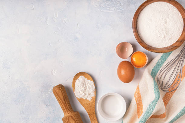 istock Ingredients for baking  - flour, wooden spoon, rolling pin, eggs. 955501556