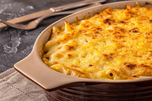 istock Mac and cheese, american style macaroni pasta in cheesy sauce 955501882