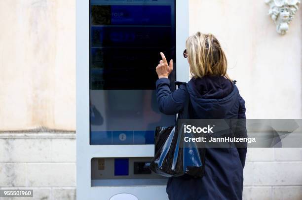 Smart City Woman Using Interactive Digital Kiosk Stock Photo - Download Image Now