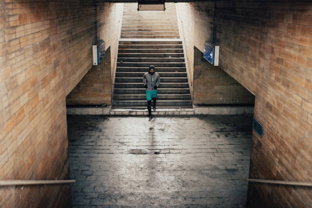 istock Bearded young adult walking down the staircase 955501962