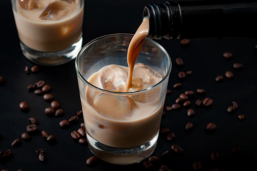 Coffee flavoured irish cream whiskey pouring in a glass