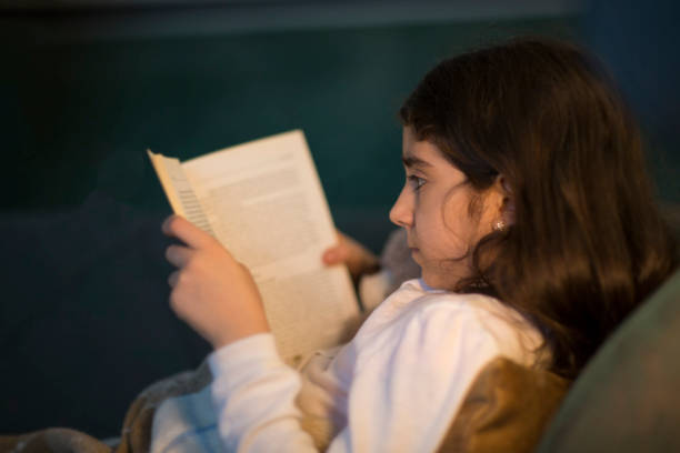 istock Little Girl Reading Book 955506620