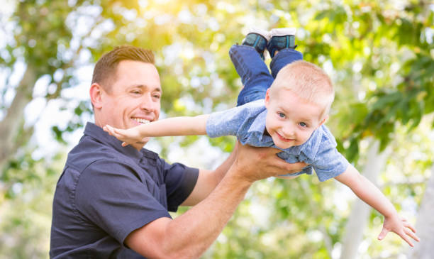 istock Young Caucasian Father and Son Having Fun At The Park 955507092