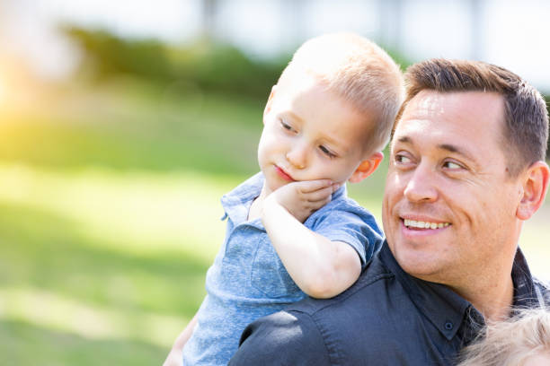 istock Young Caucasian Father and Son Having Fun At The Park 955507142