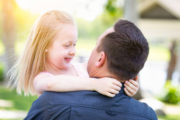 istock Young Caucasian Father and Daughter Having Fun At The Park 955507284