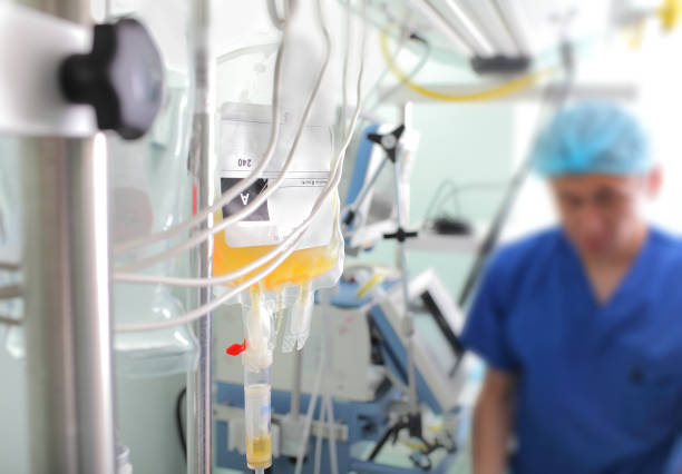 Doctors Gesturing Thumbs Up Over Patient In Hospital