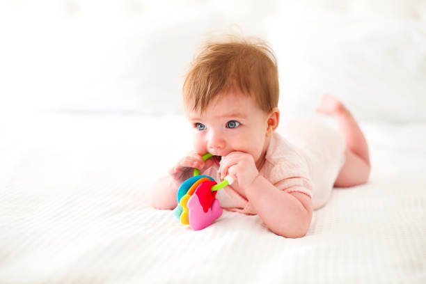 istock Six month baby playing on bed 955514784