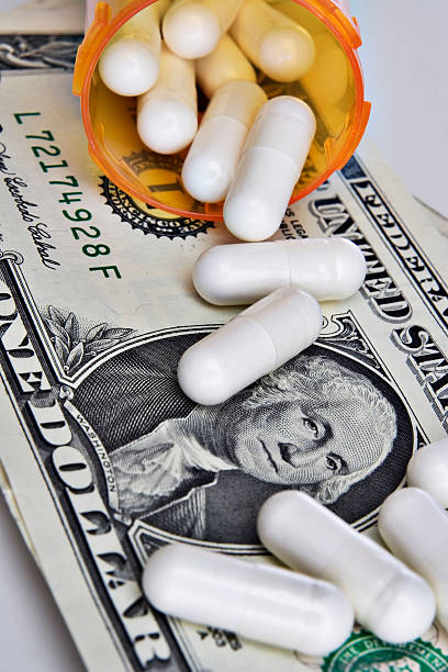 istock Pills spilling onto dollar 95551970