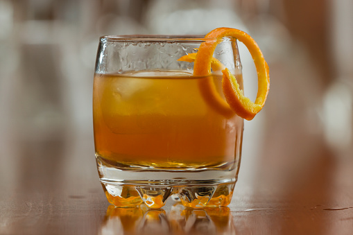 orange liquor served on the rocks with an orange twist as a garnish