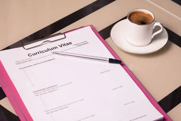 Curriculum vitae cv and a cup of fragrant coffee as a concept for job search and hiring staff.
