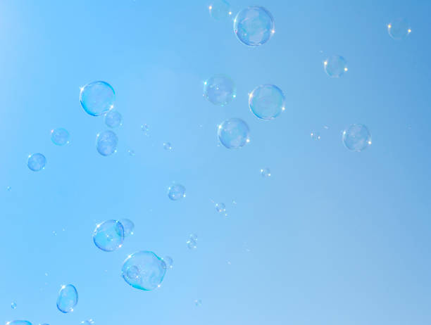 istock Soap bubbles, Blowing soap bubble on Blue sky background 955526222