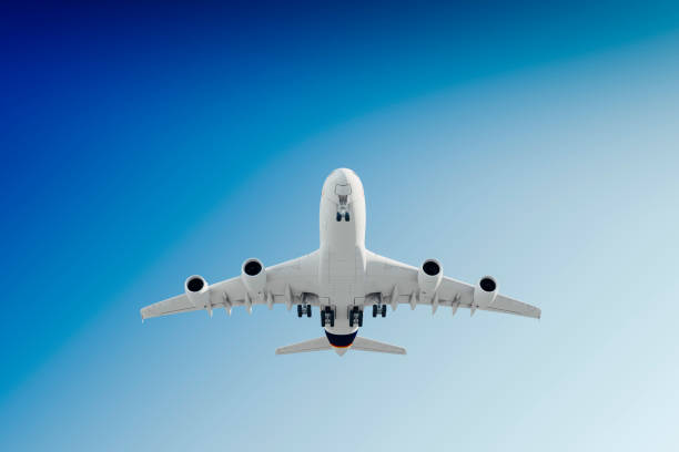 istock 3d commercial airplane, take off against perfect clear blue sky 955527156