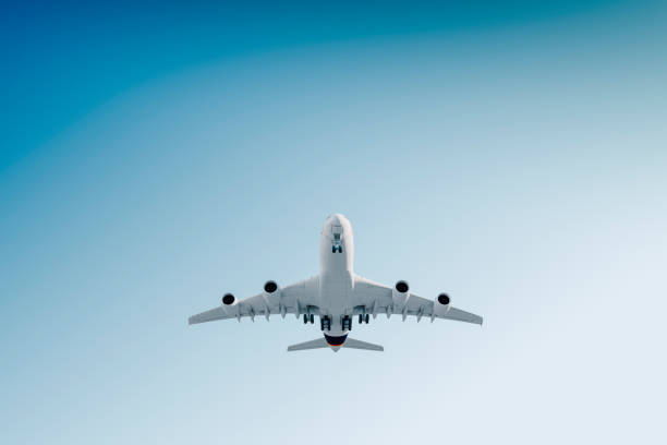 istock 3d commercial airplane, take off against perfect clear blue sky 955527162