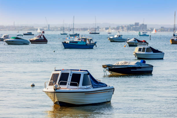 5th. May 2018 This is Poole Harbour Dorset England UK on a sunny afternoon in Spring. Small pleasure and fishing boats are moored in one of the biggest natural harbours in the world. There are no recognisable people in the picture.