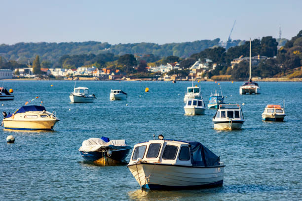 5th. May 2018 This is Poole Harbour Dorset England UK on a sunny afternoon in Spring. Small pleasure and fishing boats are moored in one of the biggest natural harbours in the world. There are no recognisable people in the picture.