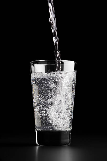 Pouring a glass of water stock photo