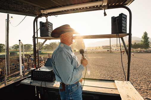 Rodeo Announcer working from elevated Booth